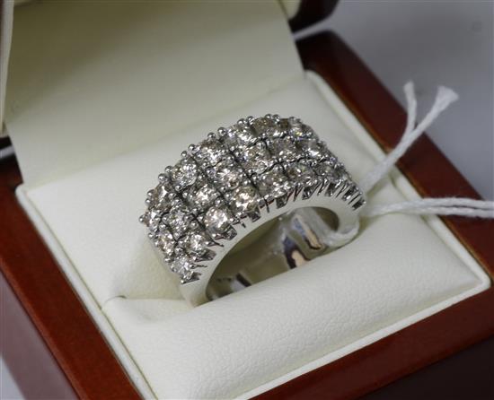 An 18ct white gold triple band diamond dress ring, size M.